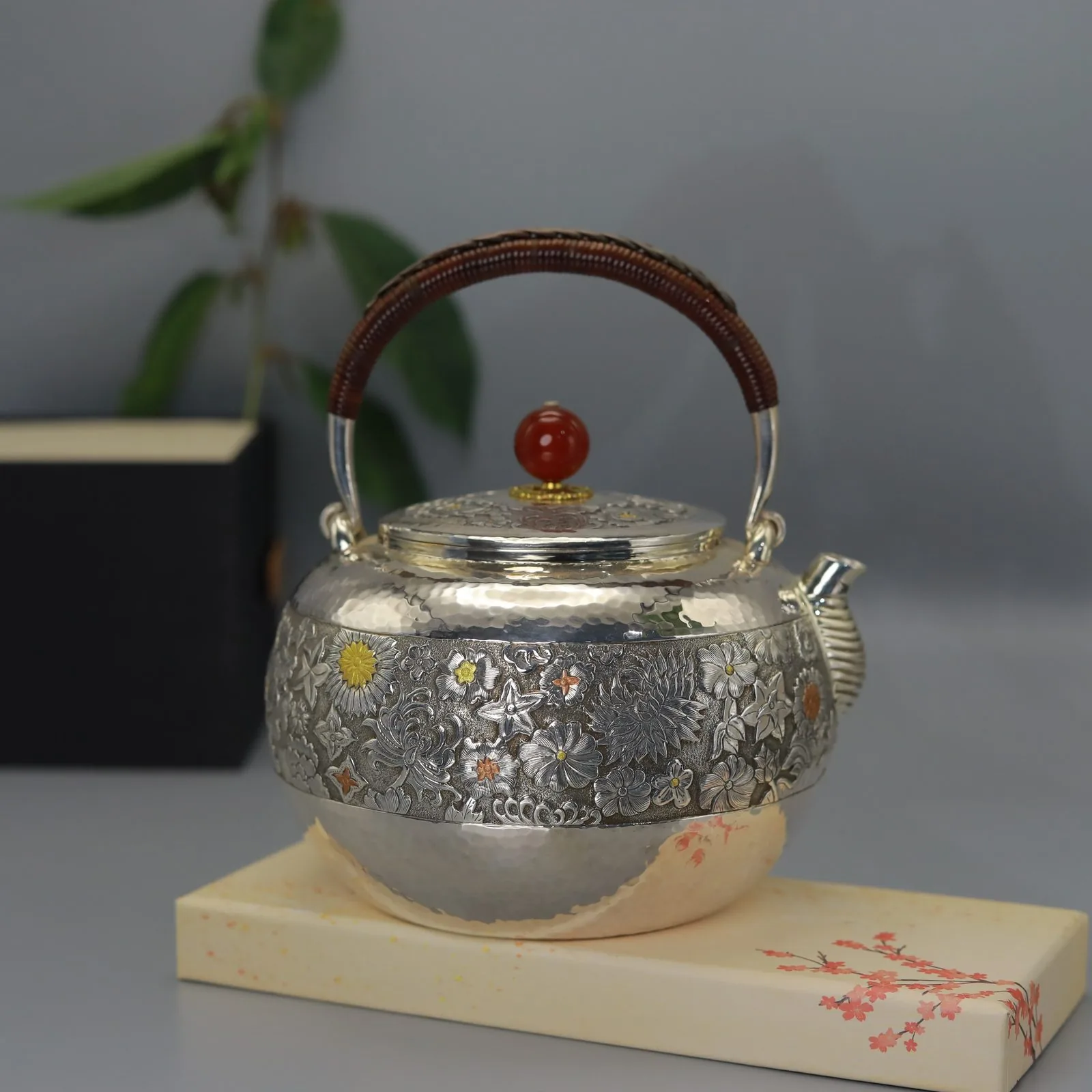 Floral teapot on a pale base