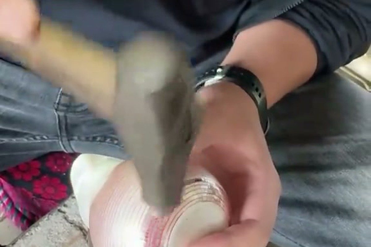 An artisan using a hammer for detailed metalwork