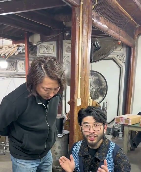 Yang Sheng and Mr Jiang beside the workshop bench