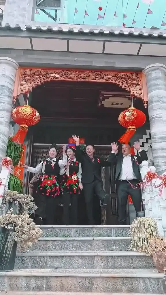Bai girls in festival dress group photo at a doorway